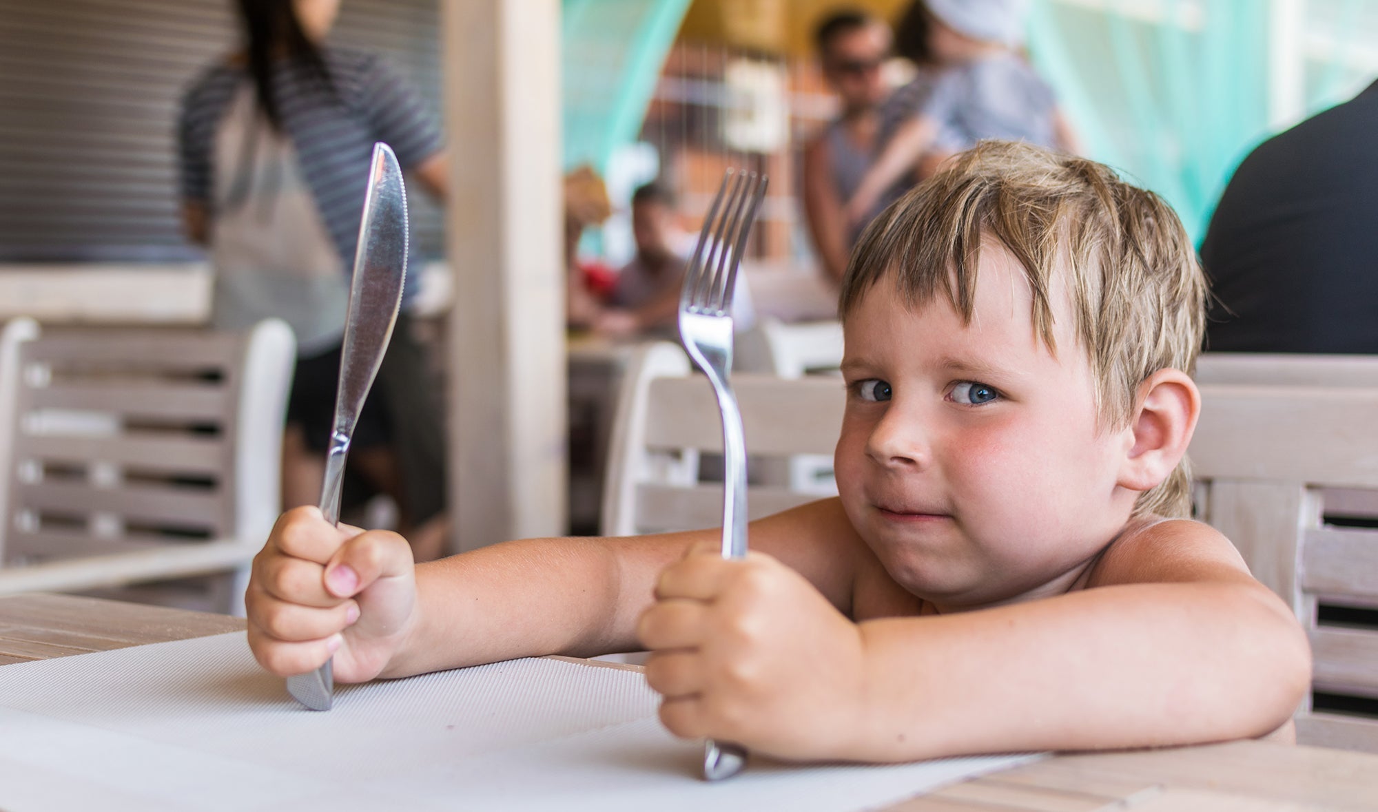 hungry child with fork and knife