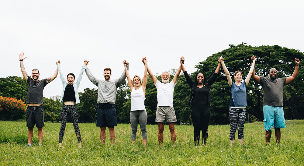 group of people cheering in field