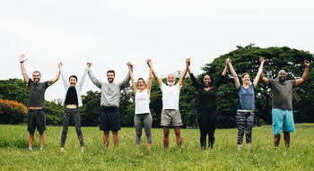 group of people cheering in field