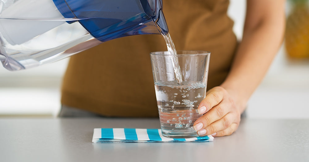 pouring water into glass