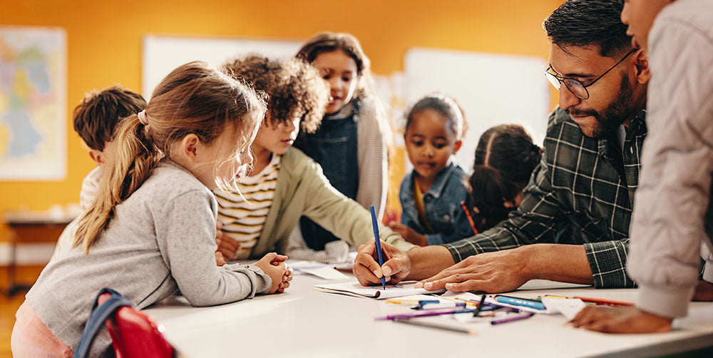kids with teacher around table 