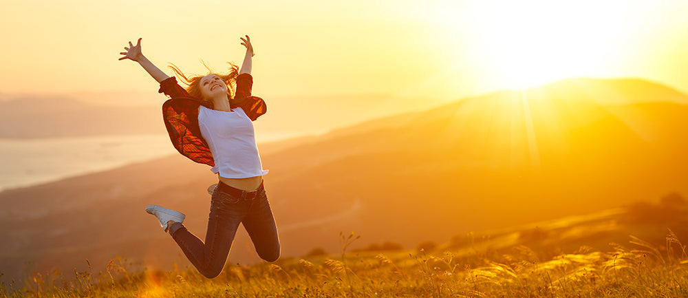 woman jumping for joy outside