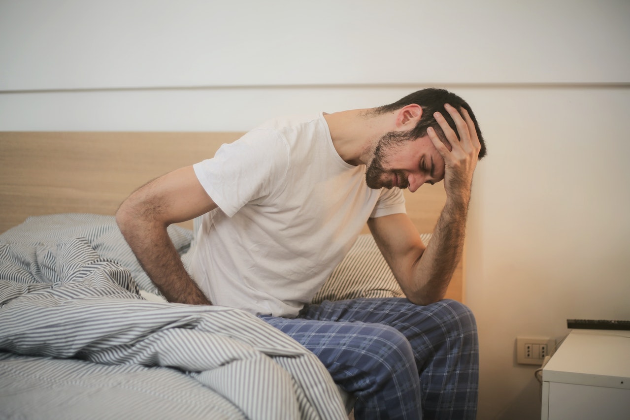 Man feeling unwell in bed